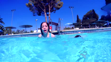 Underwater-footage-of-kids-jumping-and-diving-in-a-swimming-pool