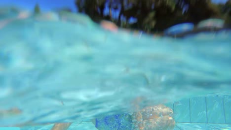 Underwater-footage-of-kids-jumping-and-diving-in-a-swimming-pool