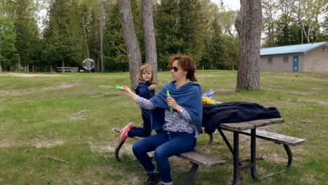 Mother-and-Daughter-Playing-with-Soap-Bubbles-in-a-Park