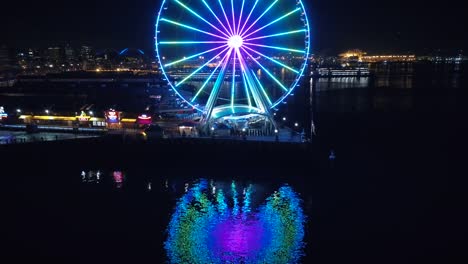 Seattle-Waterfront-Aerial-with-Ferry-Boat-Passing-Pier-at-Night