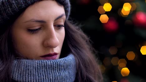 close-up-portrait-of-pensive-cute-brunette-thinking-and-smiling-at-camera--Christmas-Time--oudoor