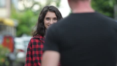 Young-couple-greeting-each-other-outdoors