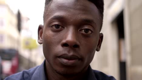 Pensive-young--african-man-staring-at-camera--outdoor