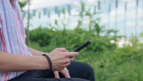 Young-Lady-with-Modern-Hairstyle-Using-Phone-in-Town