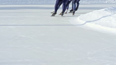 Unrecognizable-Speed-Skaters-Racing-on-Rink