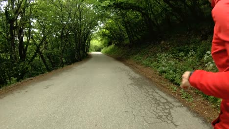 Running-girl.-Blonde-girl-doing-outdoor-sports-in-the-summer-forest.-Rear-view-slow-motion-wide-angle.-Close-up-of-a-girl's-legs