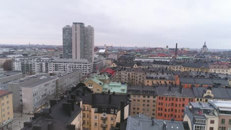 Aerial-view-of-Stockholm-city-buildings-in-Södermalm-district.-Drone-shot-flying-over-rooftops,-skyscraper-building-in-the-background