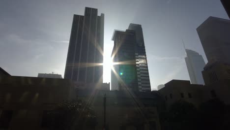 Sonne-Strahlen-zwischen-Hochhäusern-in-downtown-Los-Angeles-Street-Dolly-Schuss