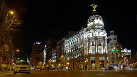 España-madrid-en-la-noche,-La-gran-via-metropolis-hotel-tráfico-de-calle-4-K