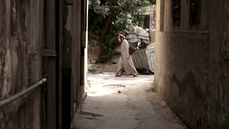 Arab-woman-walking-down-the-street-at-the-end-of-an-alley