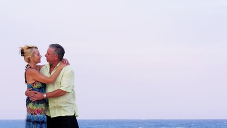 An-older-couple-kiss-on-the-beach