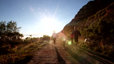 Multi-ethnic-group-of-athletes-running-on-a-footpath