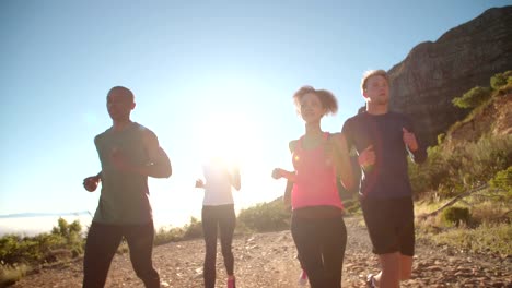 Multi-ethnic-group-of-athletes-running-on-a-footpath