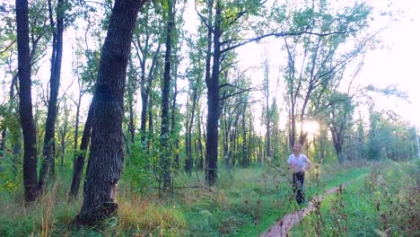 Slim-teenager-boy-is-running-on-paths-and-trails-in-the-forest.-Boy-is-trained-good-running.-Sports-in-nature.