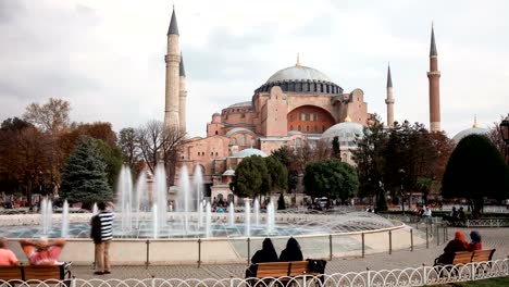 Tourists-walking-in-Sultanahmet-Square-Hagia-Sophia,-a-former-Orthodox-patriarchal-basilica,-later-a-mosque-and-now-a-museum-in-Istanbul,-Turkey