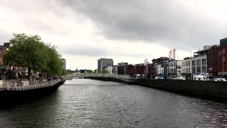 Traveling-down-a-river-in-downtown-in-Dublin-Ireland-during-overcast-day