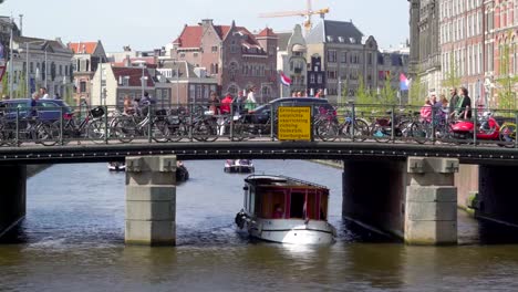 A-white-boat-getting-under-the-small-bridge