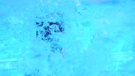 Underwater-footage-of-kids-jumping-and-diving-in-a-swimming-pool