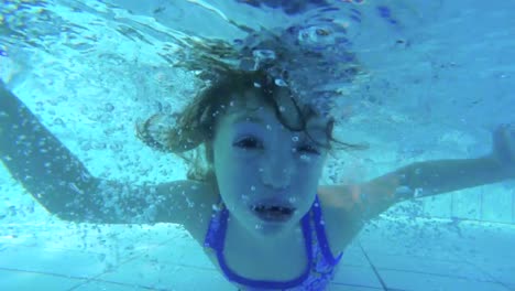 Underwater-footage-of-kids-jumping-and-diving-in-a-swimming-pool