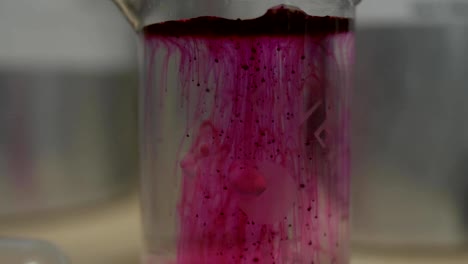 Colored-beautiful-chemical-reaction-in-flask.-Pink-or-red-liquid-dissolves-in-flask.-Pink-matter-in-the-flask.-Pink-or-red-liquid-dissolves-in-flask