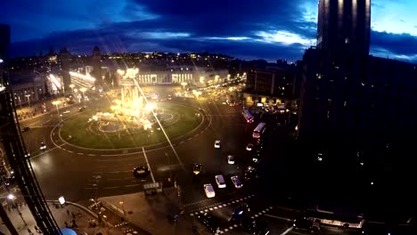 Spanish-Square-aerial-view-in-Barcelona,-Spain-at-night.-This-is-the-famous-place-with-traffic-light-trails,-fountain-and-Venetian-towers,-and-National-museum-at-the-background.-Blue-sky