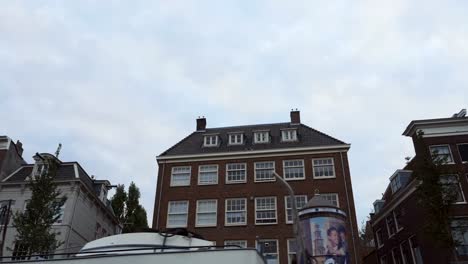 Amsterdam-Apartment-Buildings-Viewed-While-Sailing-in-a-Canal