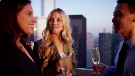 Multi-ethnic-business-team-toasting-success-on-rooftop