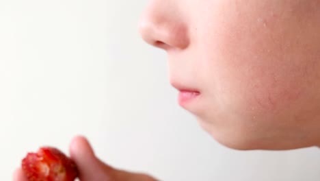 Boy-eats-strawberries.-Mouth-close-up.