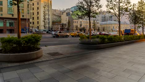 the-flow-of-pedestrians-and-cars-following-the-city-street,-time-lapse