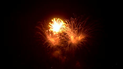 Fireworks-show.-Bright-colored-flashes-explode-in-the-night-sky-on-a-black-background.-Salute