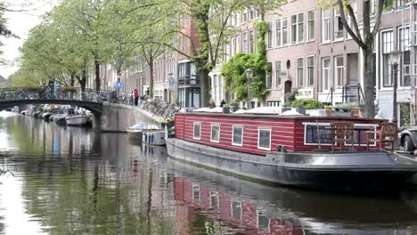 house-boat-tied-up-at-a-canal-in-amsterdam