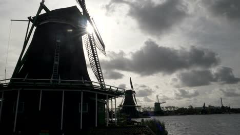 sun-behind-several-windmills-at-zaanse-schans-near-amsterdam