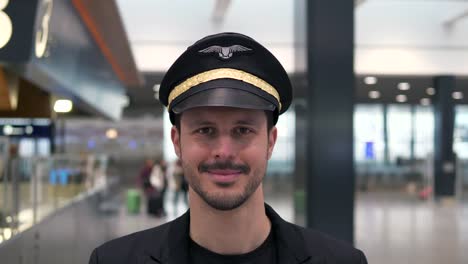 Good-looking-pilot-with-airplane-and-airport-background