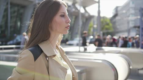 Young-adult-woman-enjoying-her-day-in-the-city-and-at-the-train-station