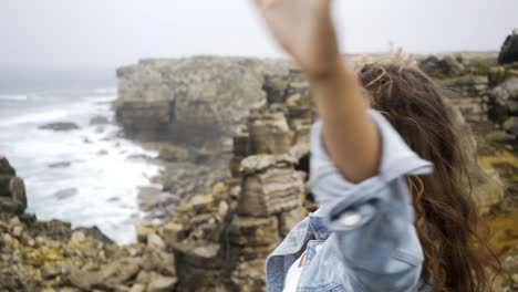 Cheerful-woman-on-rocky-seashore