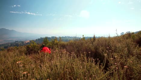 Mountain-biker-riding-a-singletrack-cross-country-trail-in-mountains