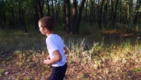 Slim-teenager-boy-is-running-on-paths-and-trails-in-the-forest.-Boy-is-trained-good-running.-Sports-in-nature.