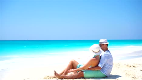 Junges-Paar-am-weißen-Strand-während-der-Sommerferien.-Glücklich-Liebhaber-genießen-ihre-Flitterwochen.