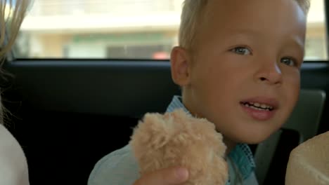 Boy-with-Plush-Toy-on-the-Car-Back-Seat