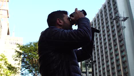 Man-photographing-the-Avenida-Paulista,-Sao-Paulo,-Brazil