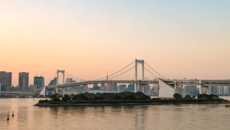 Tokyo-sunset-city-skyline-day-to-night-timelapse-at-Rainbow-Bridge,-Odaiba,-Tokyo,-Japan-4K-Time-lapse