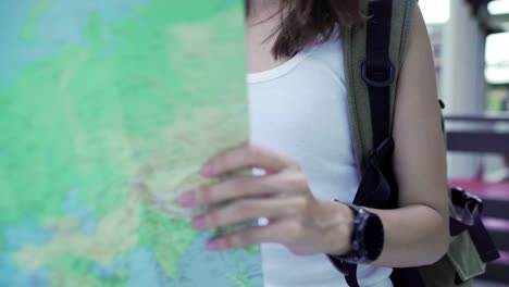 Cheerful-beautiful-young-Asian-backpacker-woman-direction-and-looking-on-location-map-while-traveling-at-Chinatown-in-Beijing,-China.-Lifestyle-backpack-tourist-travel-holiday-concept.