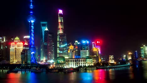 Night-time-lapse-of-the-Huangpu-river,-the-Pudong-financial-business-district,-and-the-Bund,-Shanghai-skyline,-urban-China