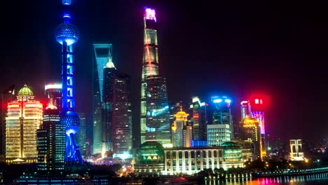 Night-time-lapse-of-the-Huangpu-river,-the-Pudong-financial-business-district,-and-the-Bund,-Shanghai-skyline,-urban-China