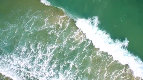 waves-of-sea-run-to-sandy-shore-aerial-view