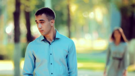 Girl-approaches-the-guy-from-behind-and-closes-her-eyes-with-her-palms