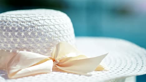 Close-up-of-elegant-white-female-sun-hat-with-winding-bow