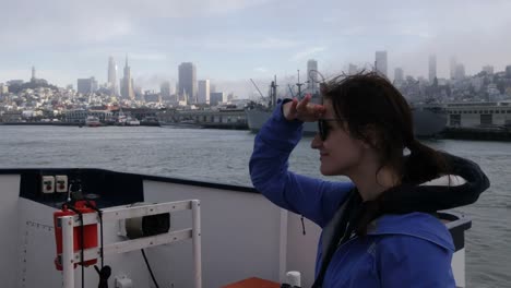 Girl-looking-at-San-Francisco-downtown-from-the-boat