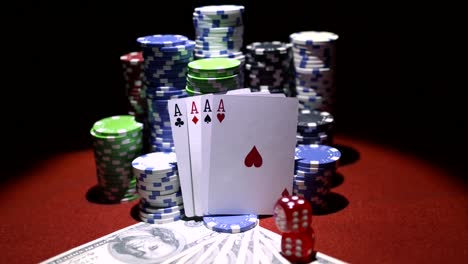 Four-aces,-dollars-and-stack-of-gambling-chips-on-red-casino-table