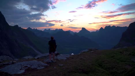 Woman-traveler-on-a-background-of-mountains-takes-photos-on-a-mobile-phone